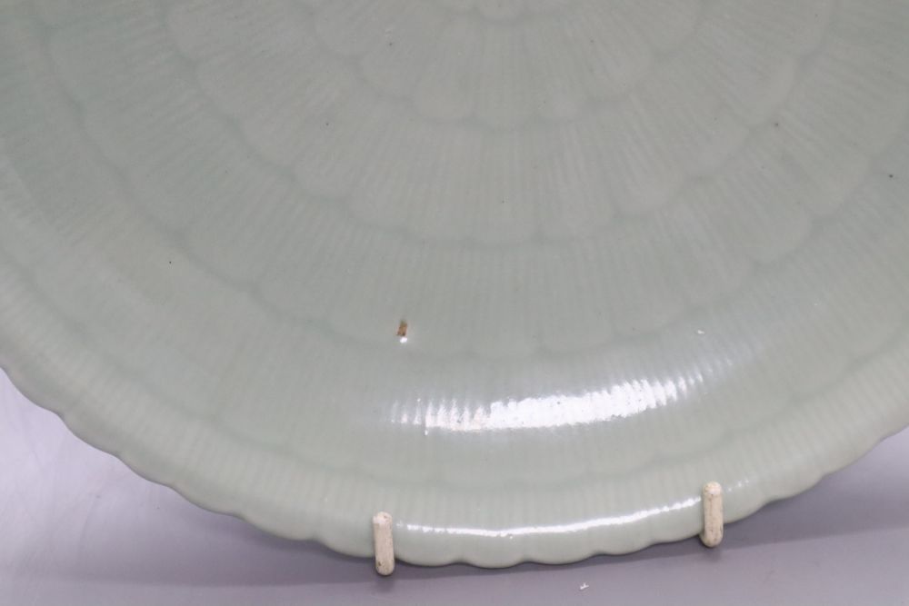 A Chinese celadon glazed dish, 18th / 19th century, Qianlong mark, diameter 28cm